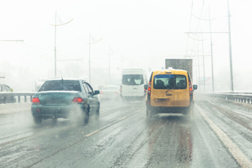 cars driving on the road inclement weather conditions