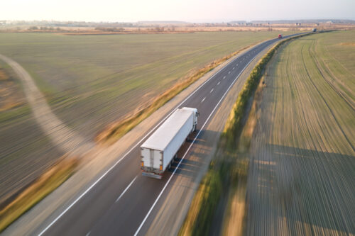 18-wheeler truck driving on road