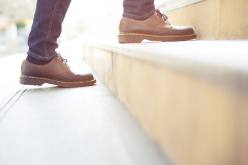 modern businessman working close-up legs walking up the stairs