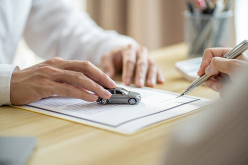 Loss Adjuster Insurance Agent Inspecting Damaged Car. .Sales manager giving advice application form document considering mortgage loan offer for car insurance
